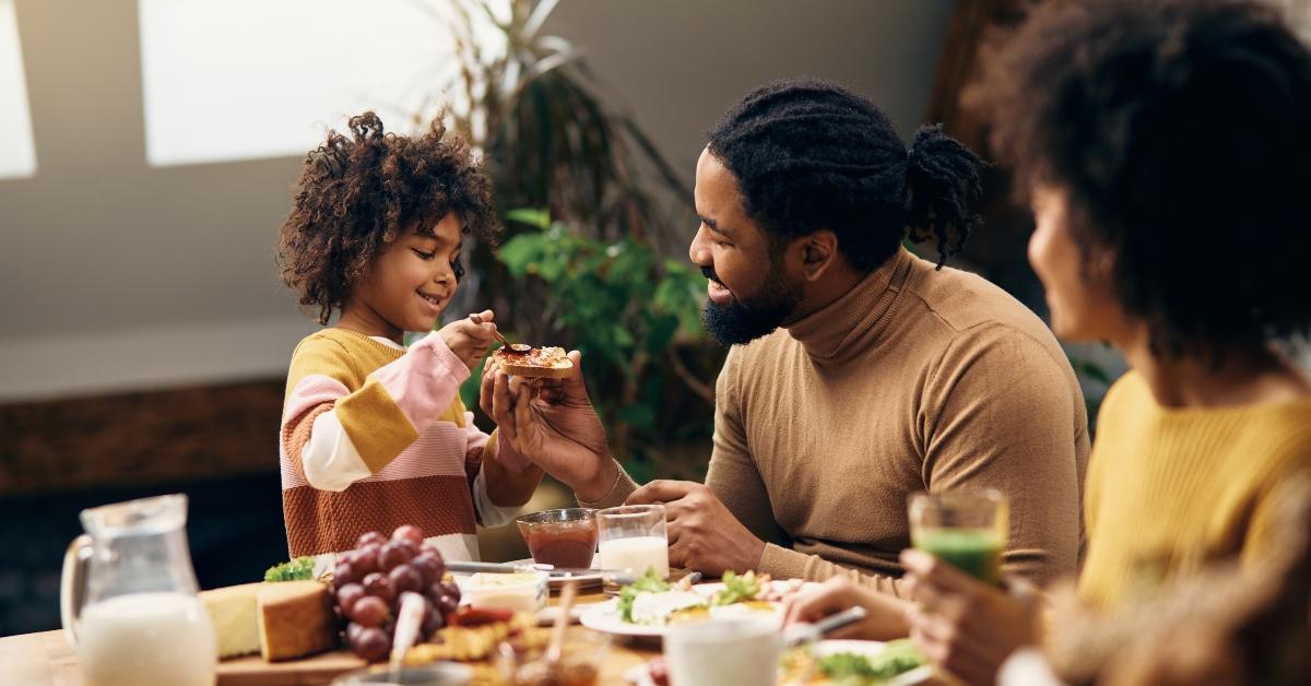 family eating jam and toasted bread for breakfast