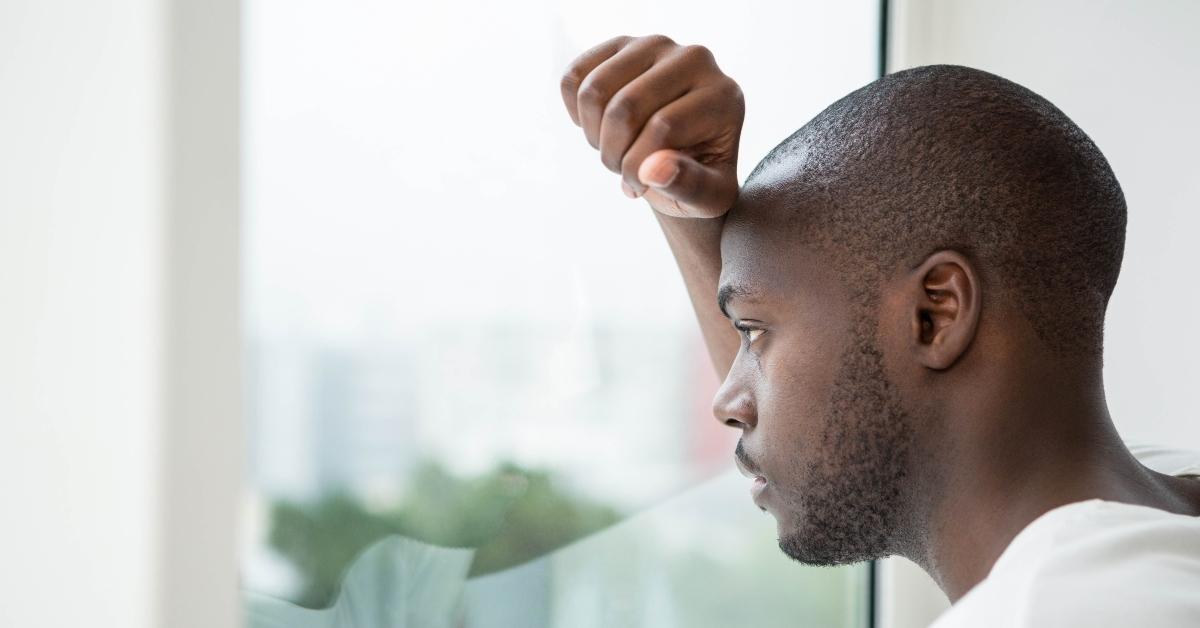 thoughtful man looking out the window
