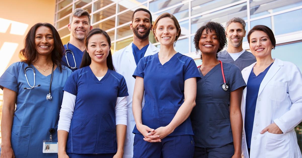 medical team standing together outside a hospital