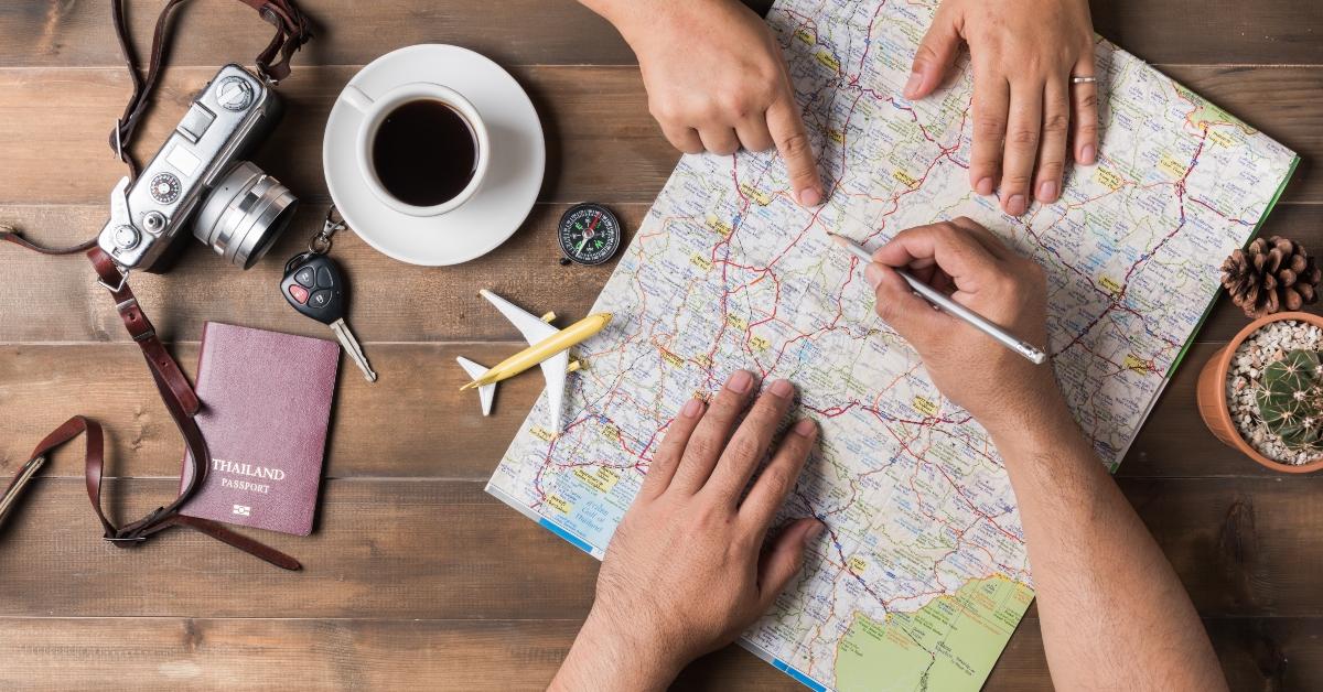 couple planning vacation trip with map
