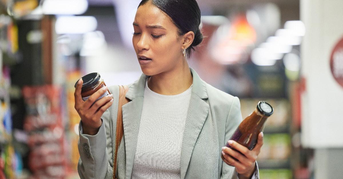woman reading labels of product in store