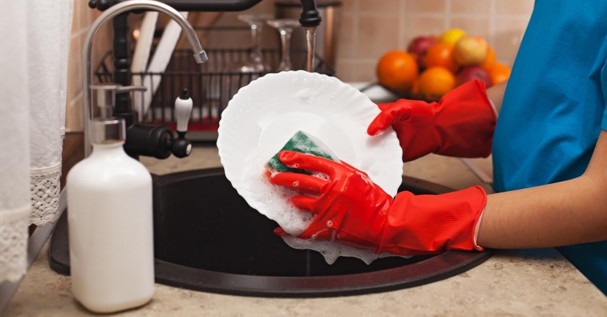 child hands scrubbing a plate