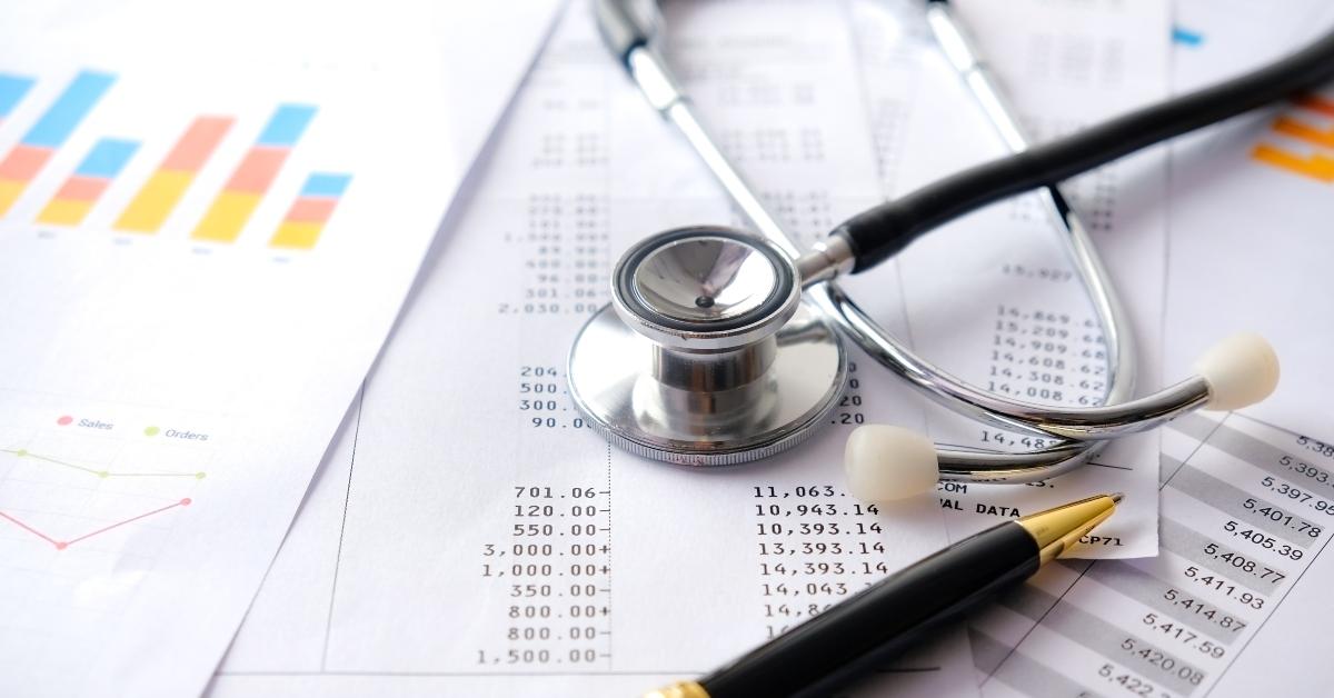 stethoscope with pen graphs and charts
