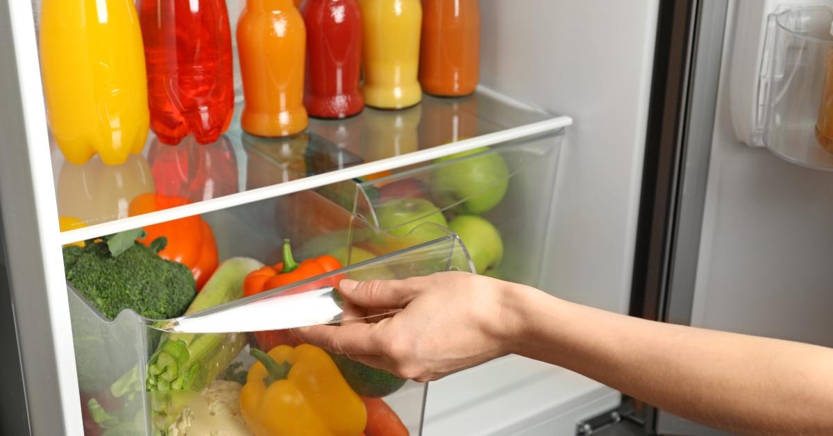 opening drawer of refrigerator with vegetables