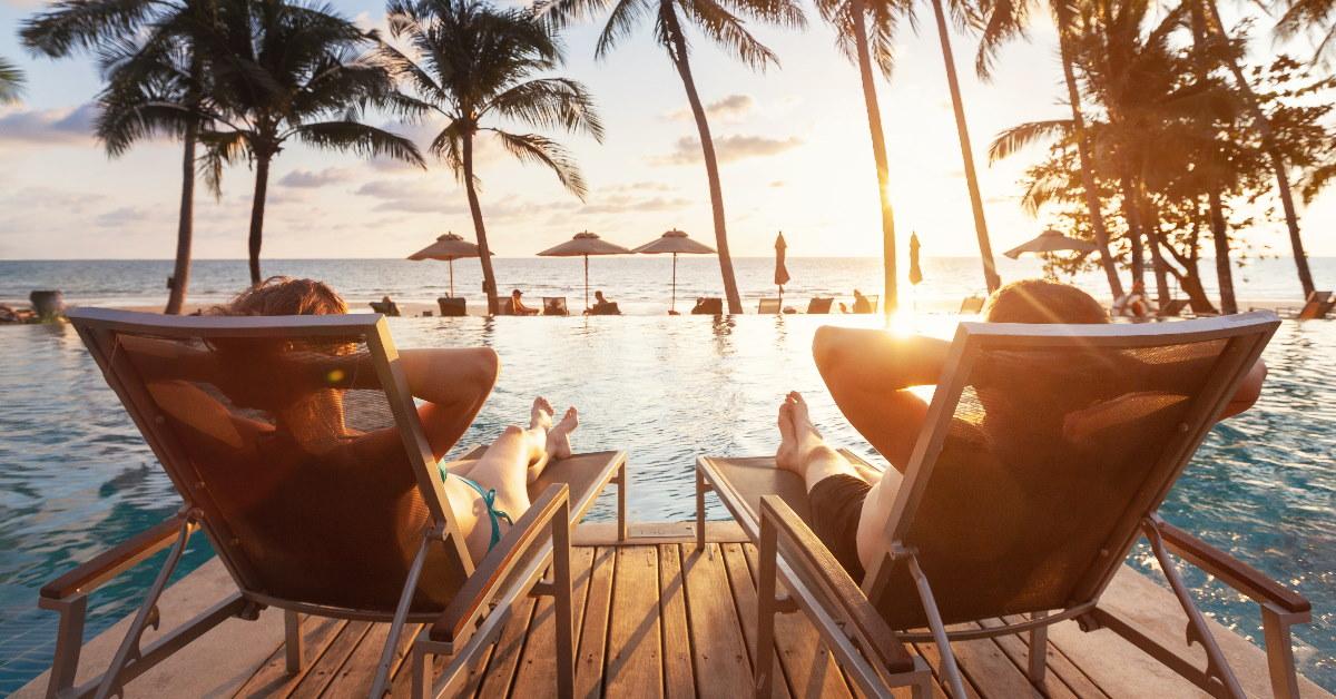 couple relaxing at poolside in a luxurious resort 