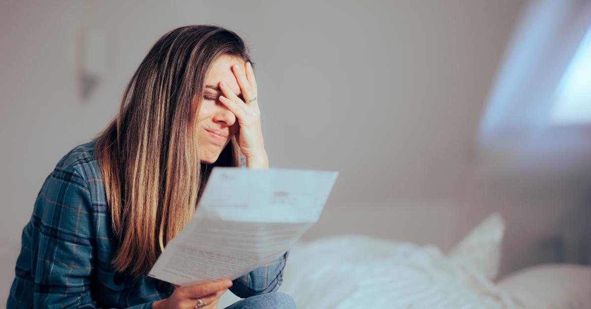 unhappy woman reading a document at home