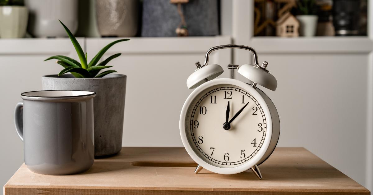 alarm clock stands on a wooden table