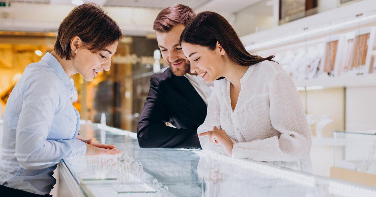 happy couple shopping in jewellery shop 