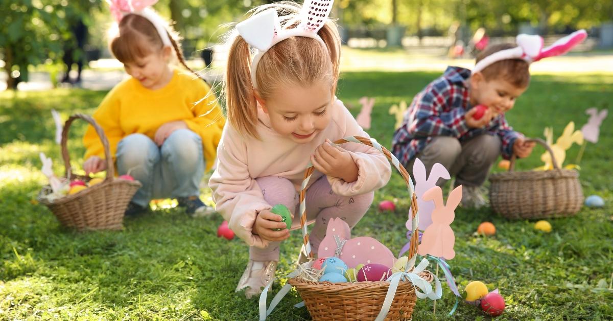 little children hunting eggs in park