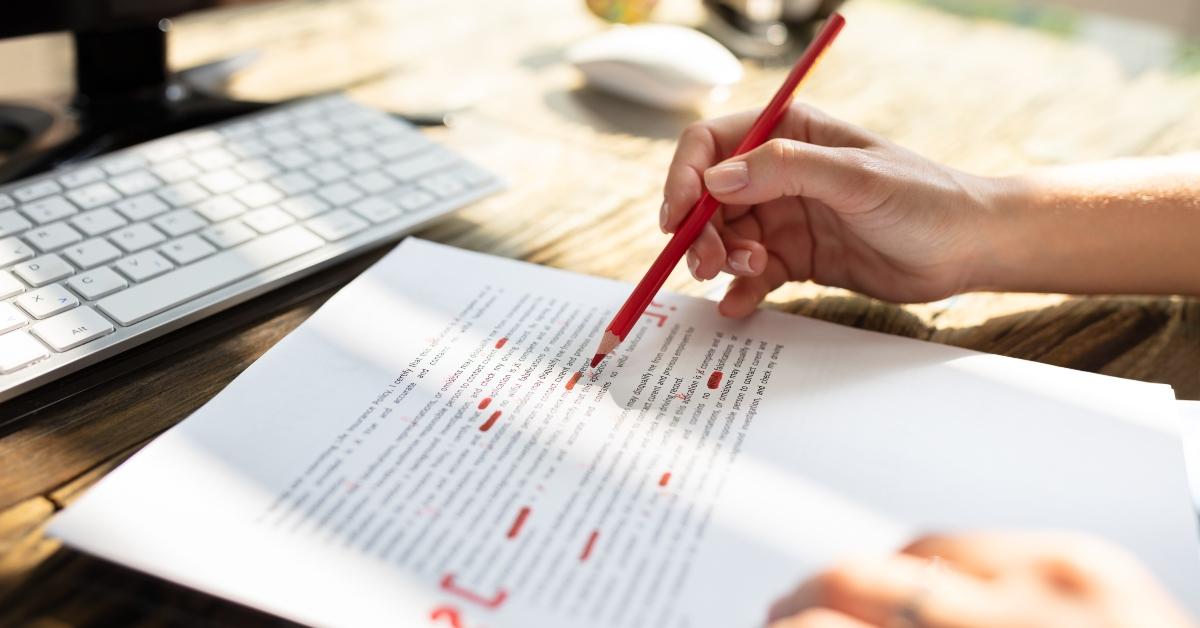 person marking error with red marker