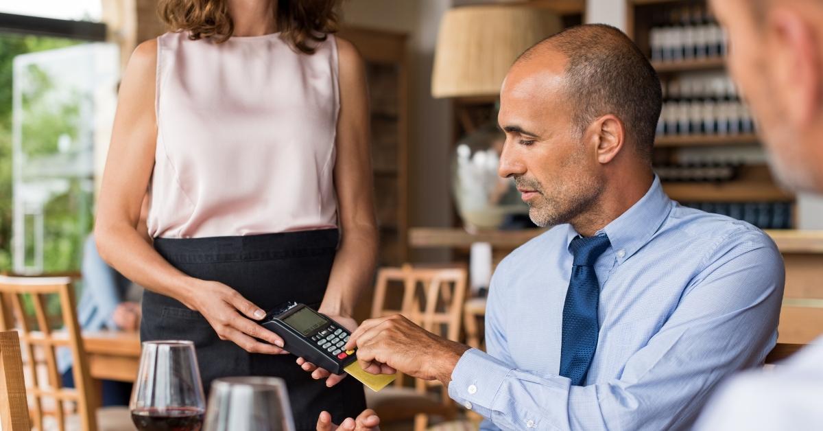 businessman swiping credit card