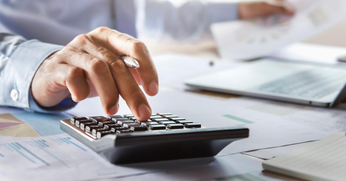 accountant working on desk using calculator