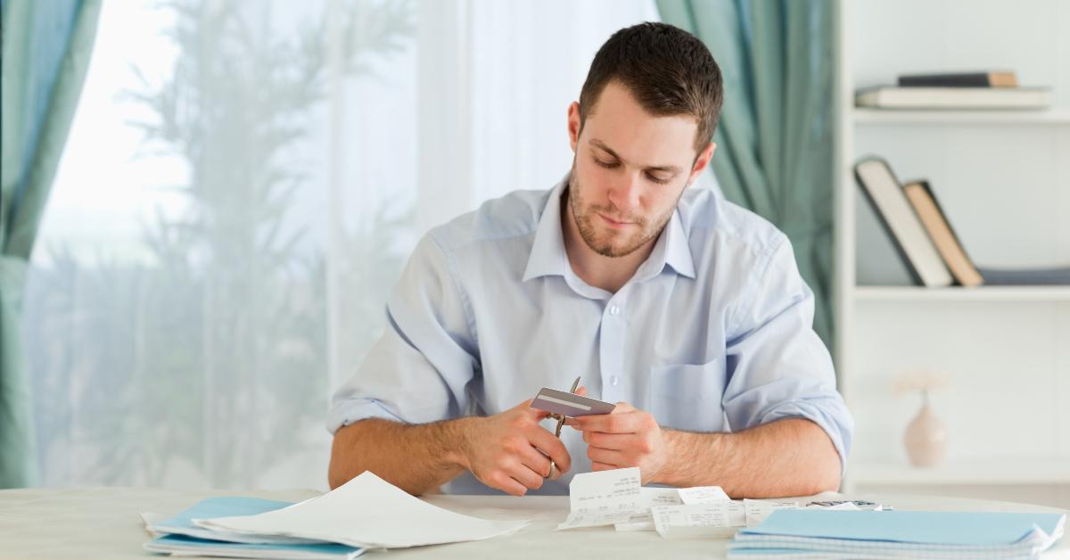 businessman destroying his credit card