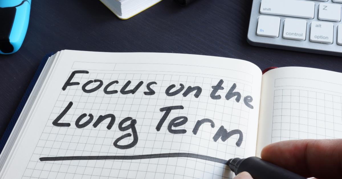 man is writing focus on the long term