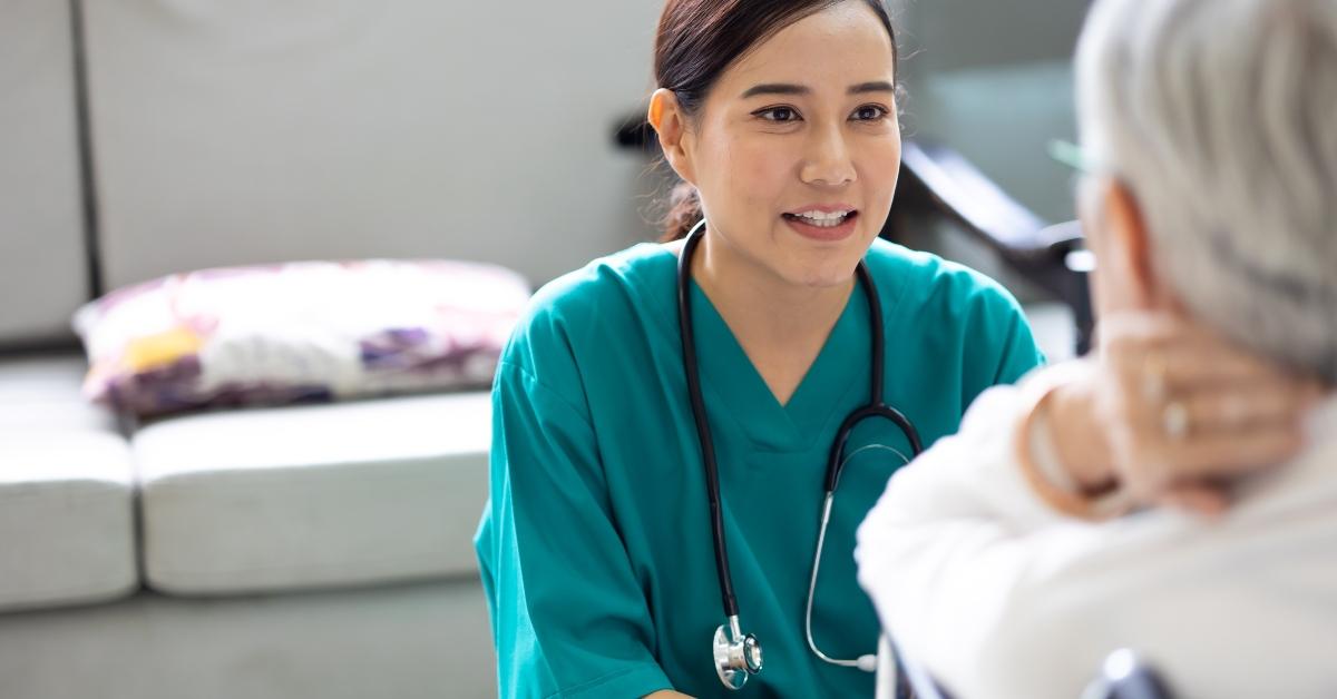 female nurse talking with senior patient
