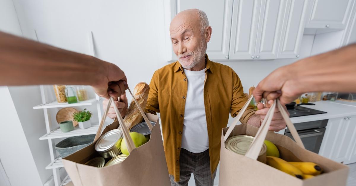 pensioner taking bags with food 