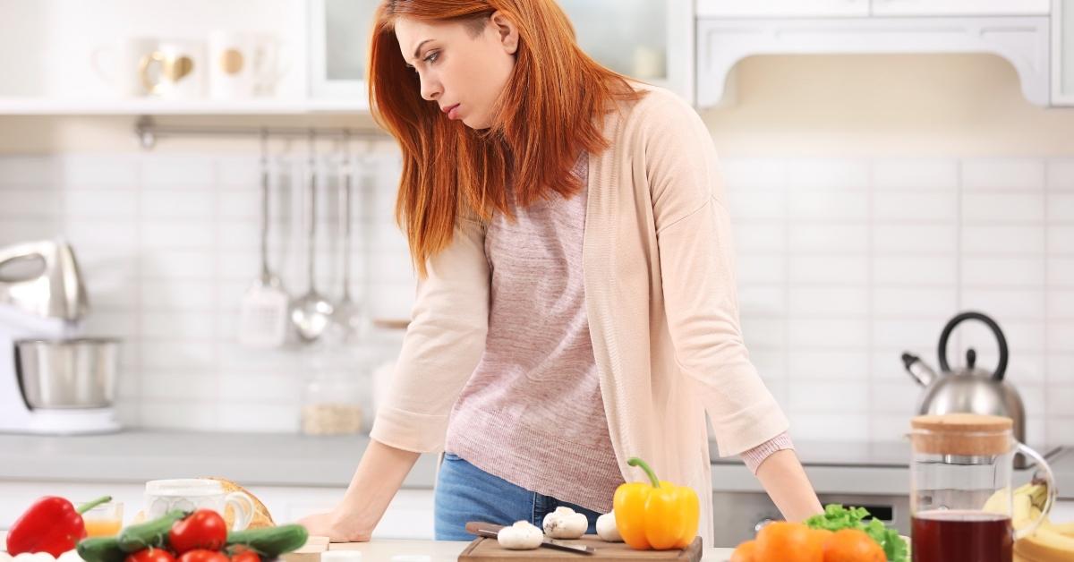tired housewife cooking in kitchen