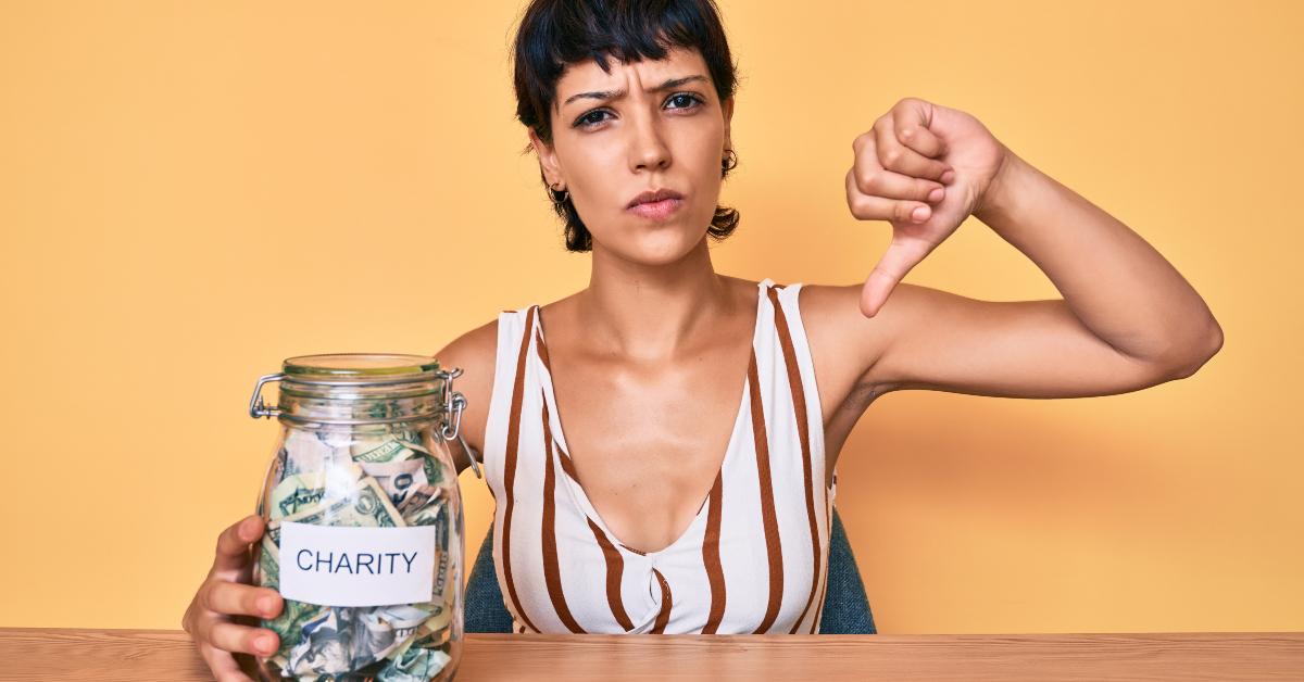 angry woman holding charity jar with money 