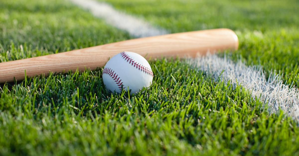 baseball bat and ball on grass near field stripe