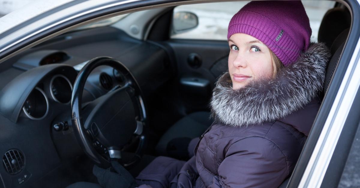 woman in winter clothes sitting in his car