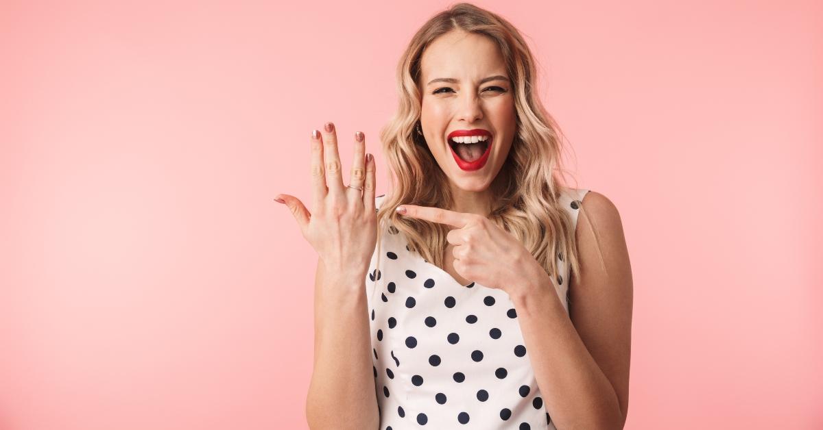 excited young blonde woman wearing dress