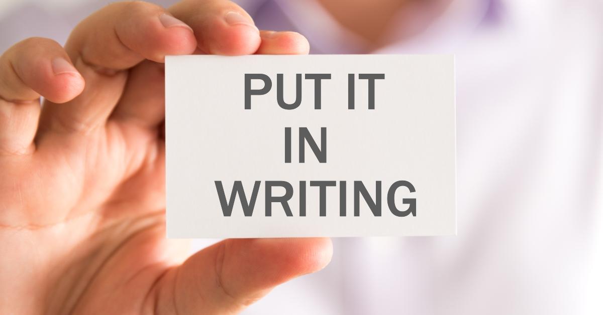 businessman holding a card with put it in writing message