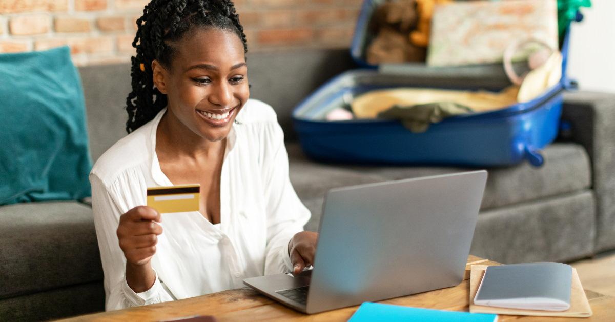 black woman making hotel reservation online using credit card