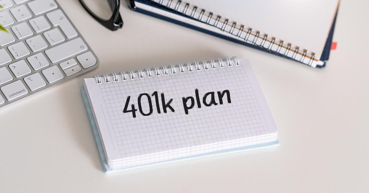 Text 401K Plan with keyboard, calculator, notepad