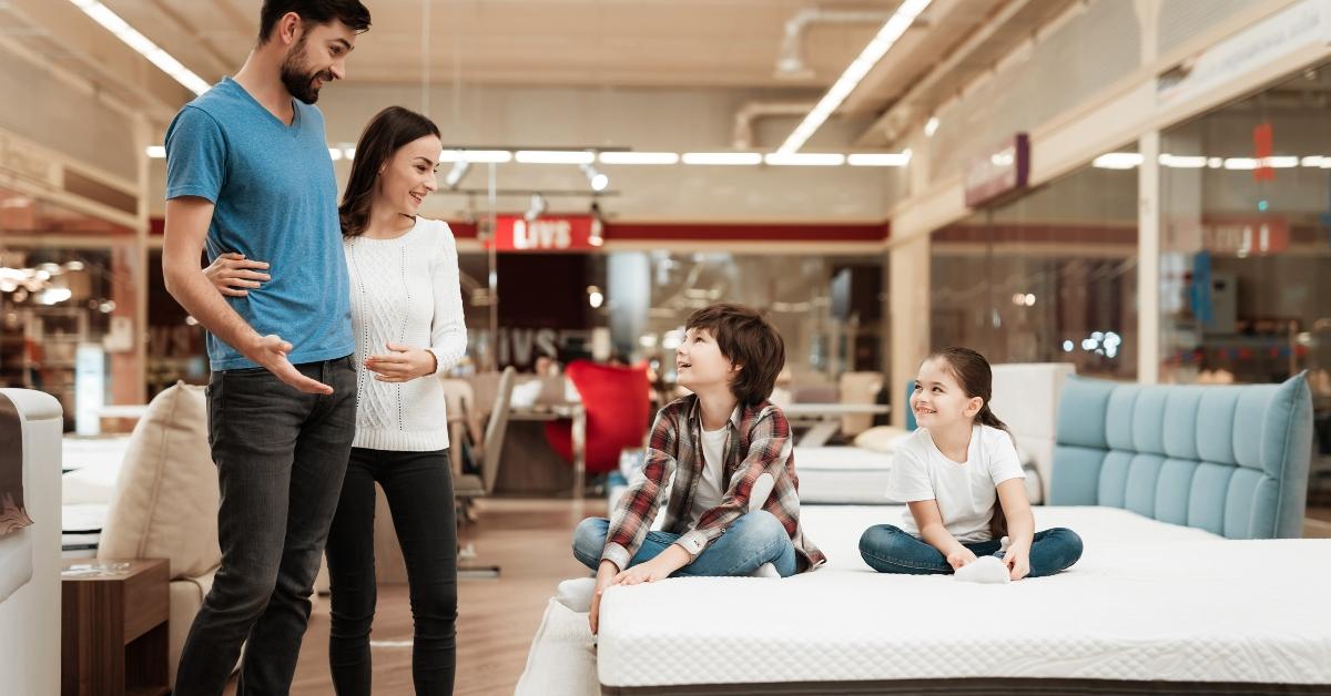 happy family came in furniture store to buy mattress