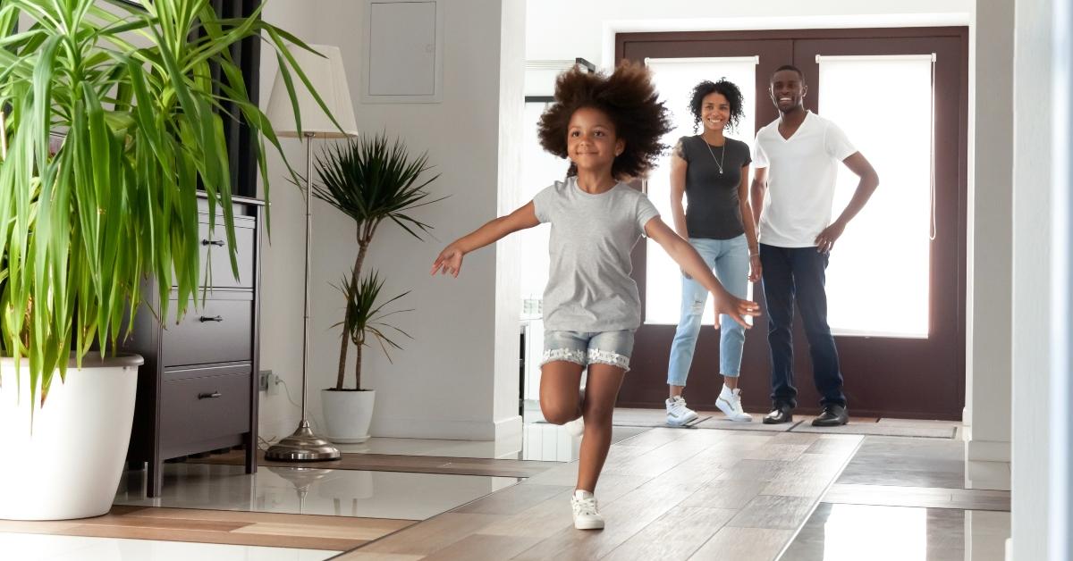 parents and kid daughter coming into new home