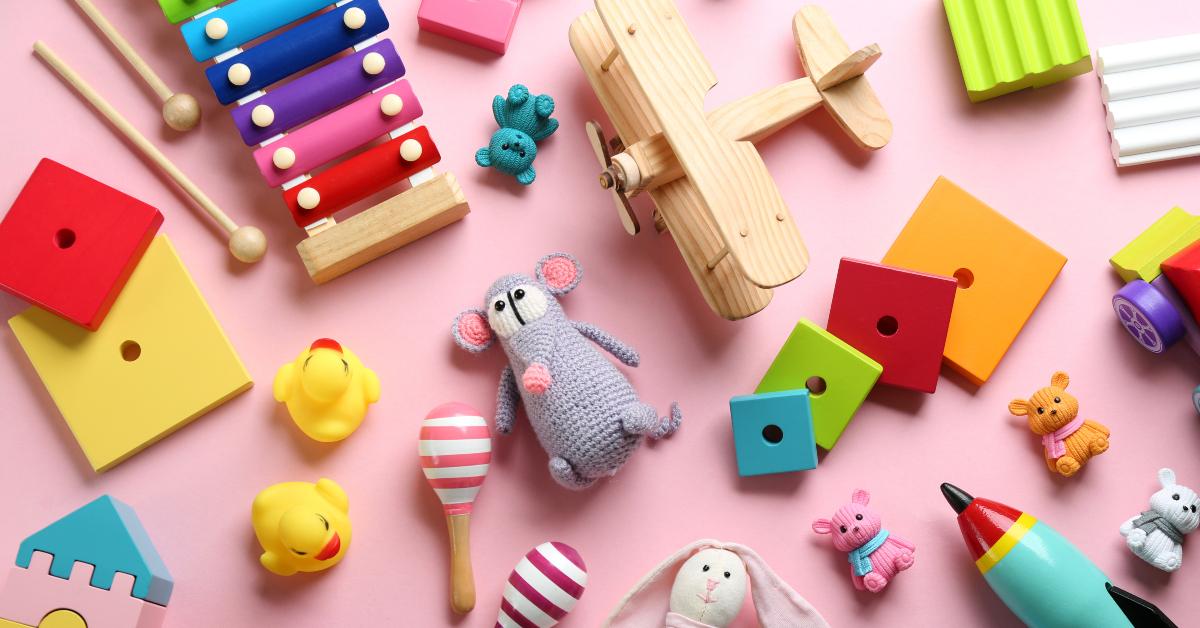 different toys on pink background