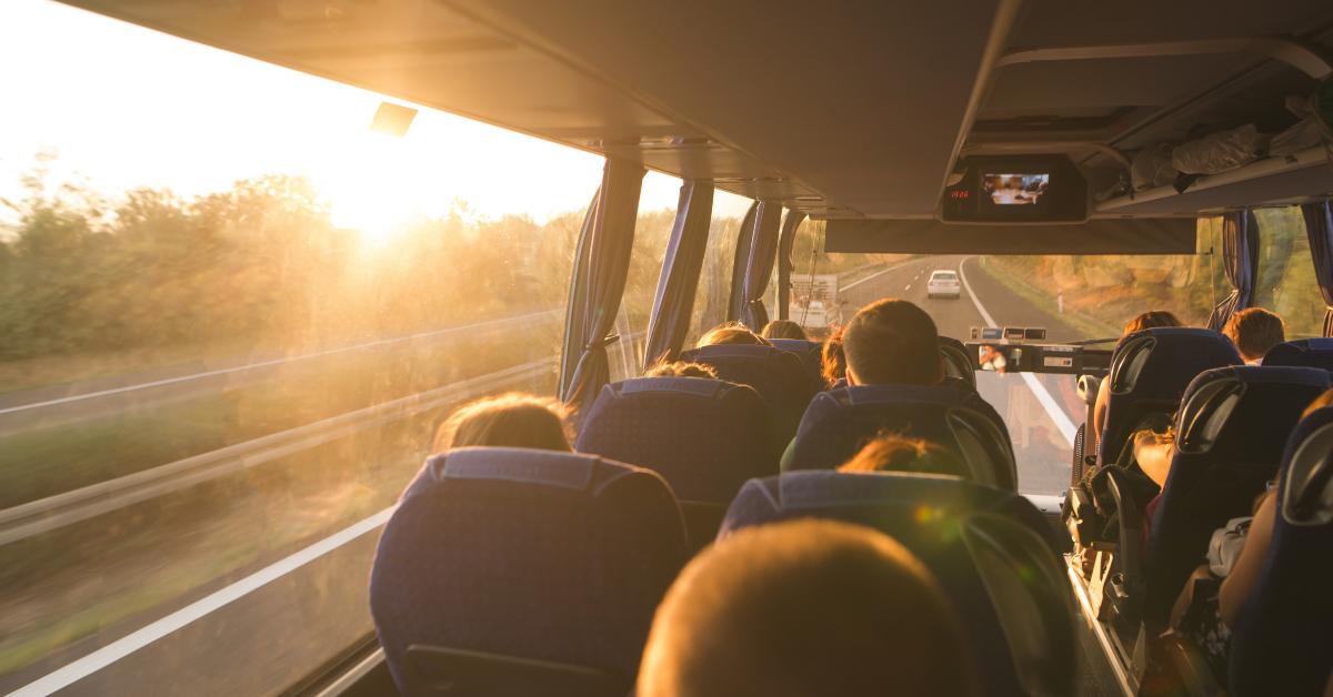 people travel on a big tourist bus