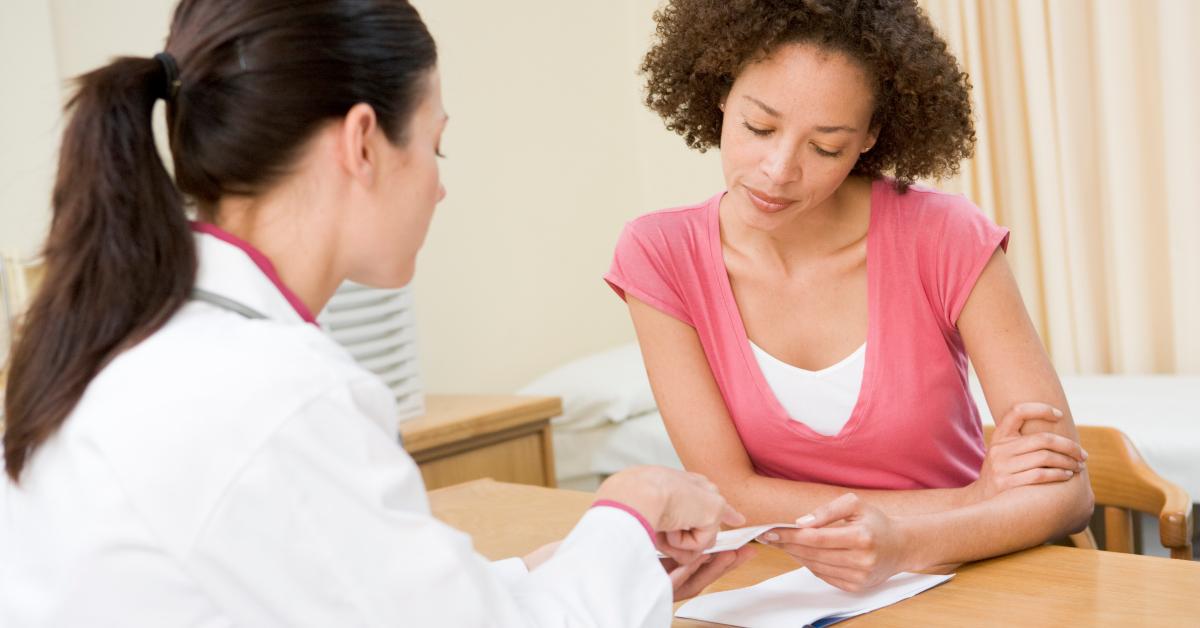 woman in doctor's office frowning