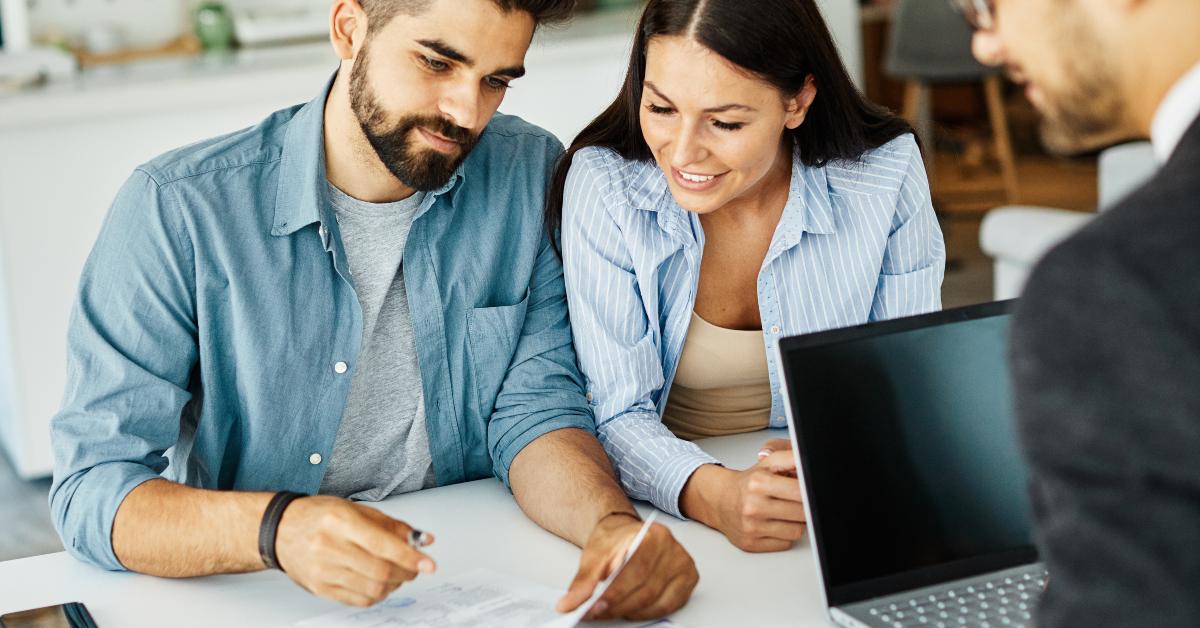 young couple signing a contract deal in real estate