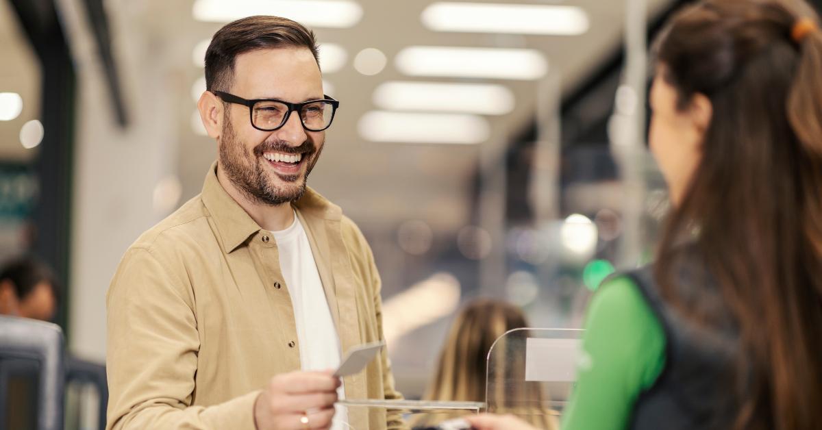 man on checkout is paying with credit card on pos terminal