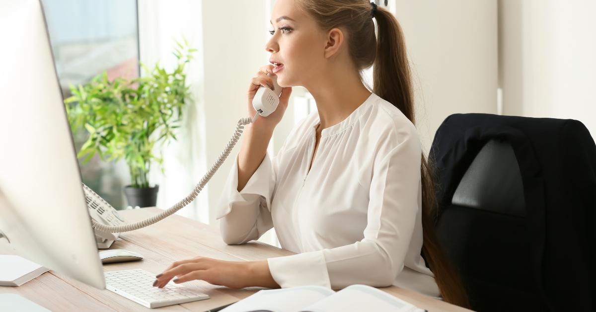 female secretary talking on telephone in office