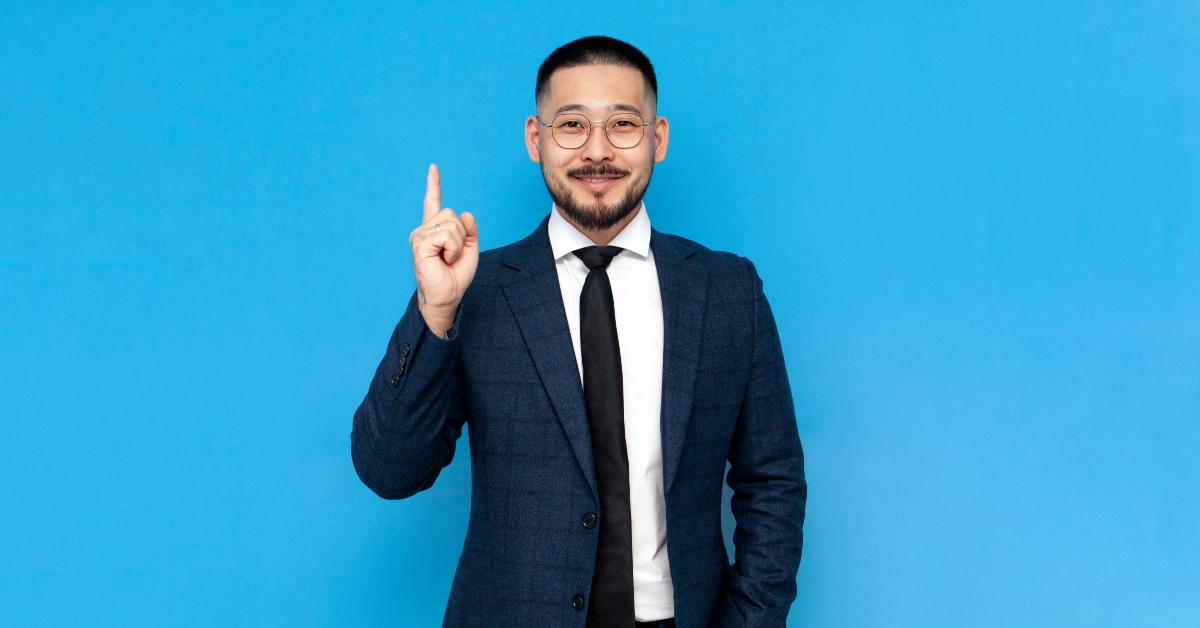 asian businessman in suit thumbs up