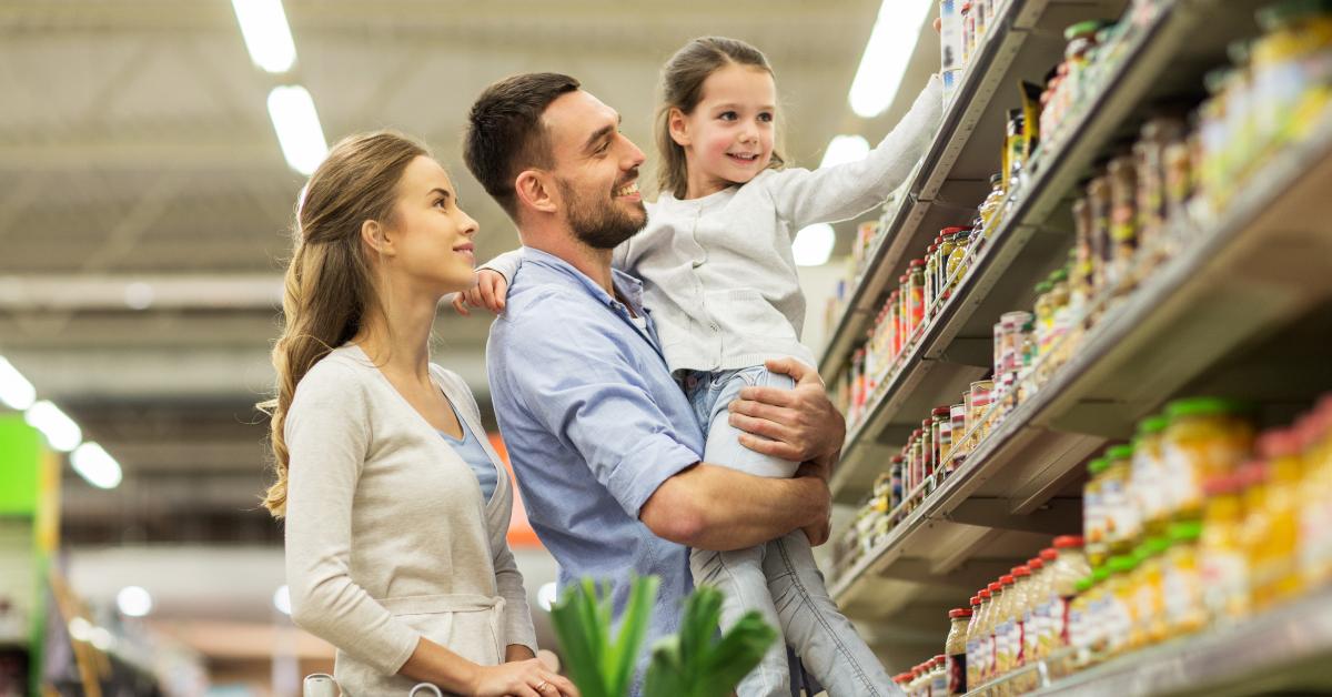 family with food in shopping cart at grocery store
