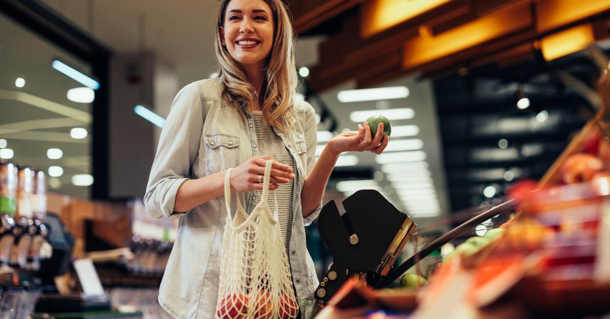 young woman buying groceries at the supermarket
