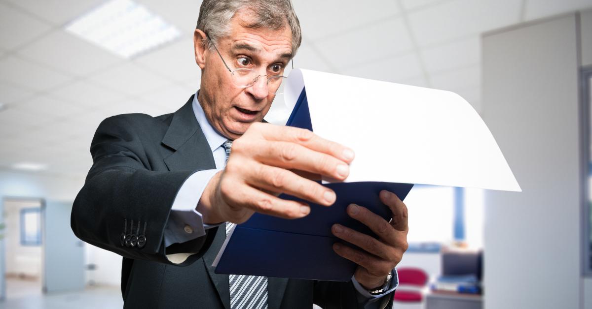 surprised businessman reading a document