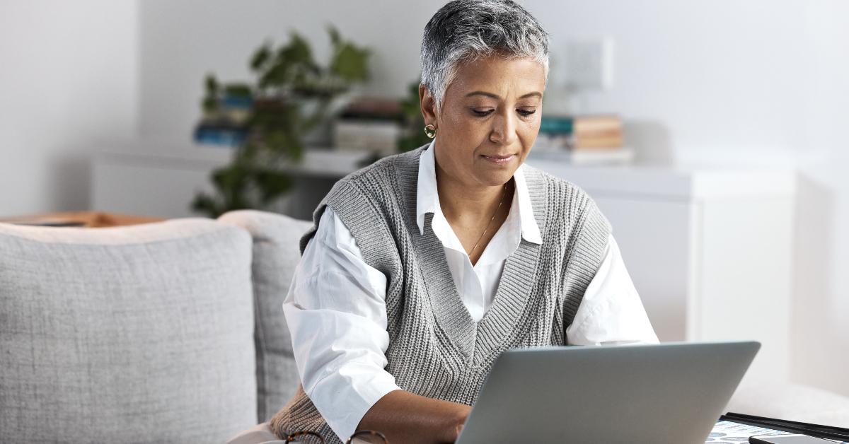 senior woman typing on laptop