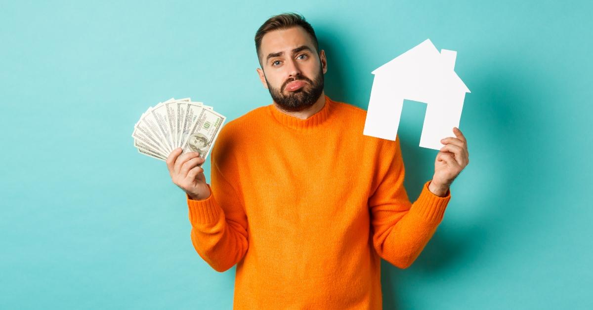 Man holding money and a house