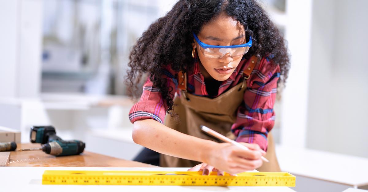 carpenter concentrates on ruler drawing