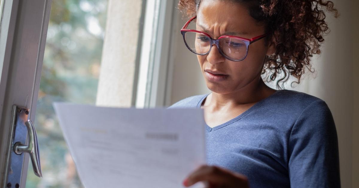 Woman looking at a bill stressed