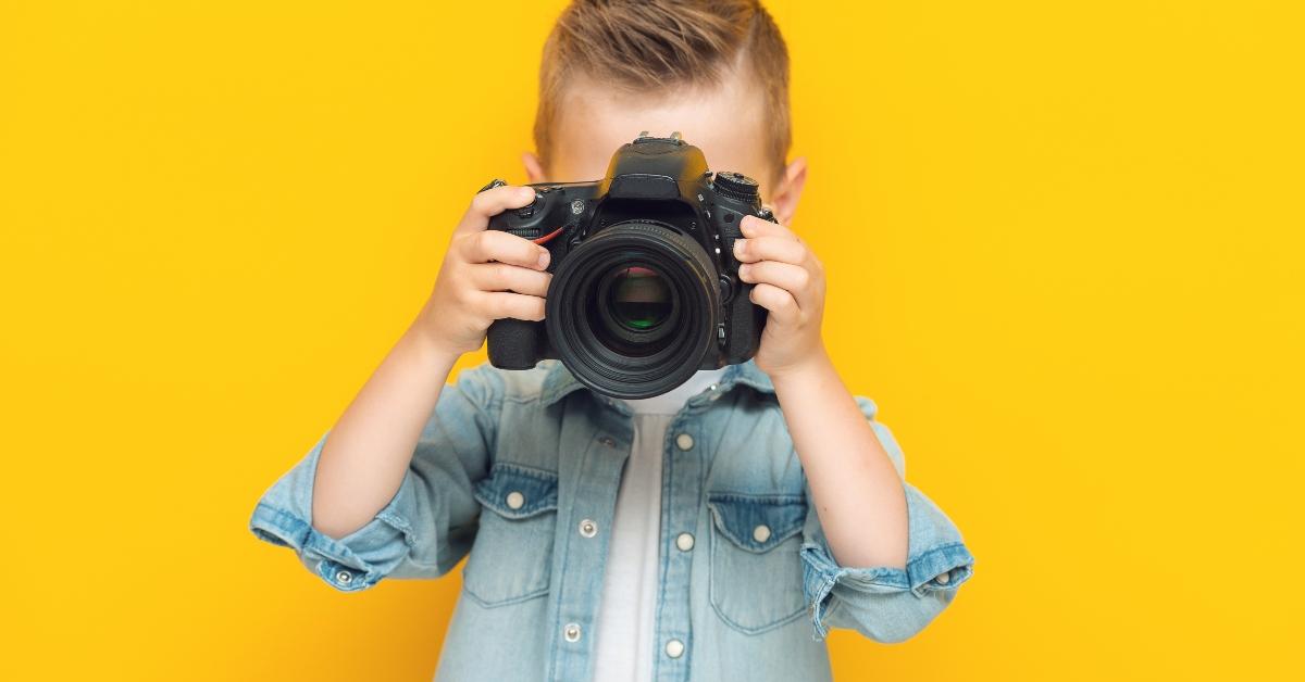 Adorable little kid taking a photo