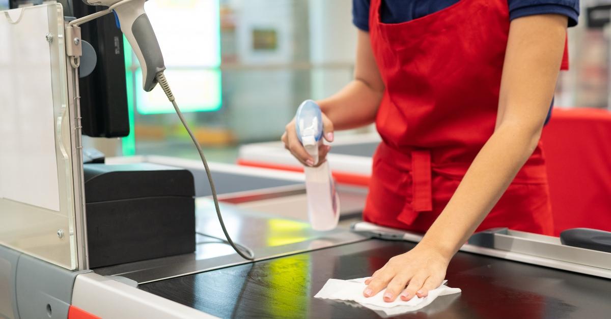 Cashier wearing red apron