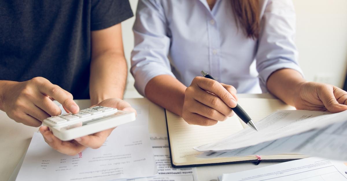 men and women are together analyzing expenses