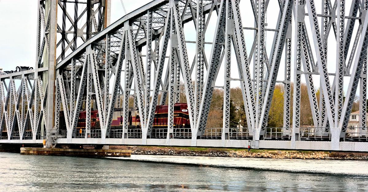 Cape cod railroad bridge with a train crossing