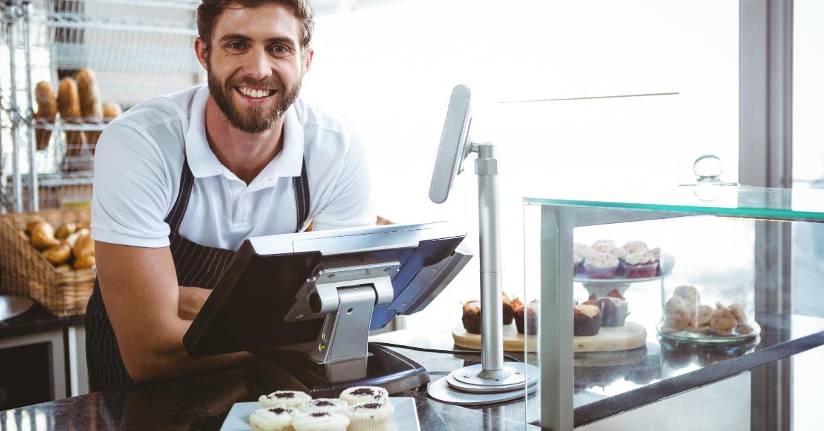 worker posing behind the counter