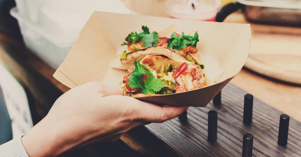 street vendor hands making taco